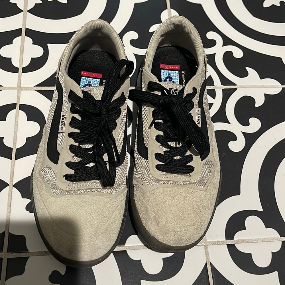 Vans, tan and black shoes